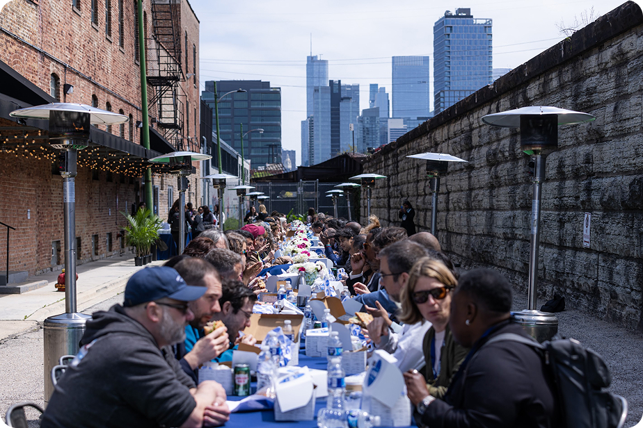 Numerous people sitting at a very long table